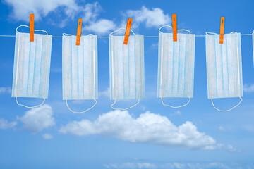 Drying mask hanging under the sun after use for disinfecting. Copy space available.