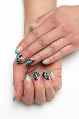 mint french manicure with black painting, silver crystals on short sharp nails on a white background close-up