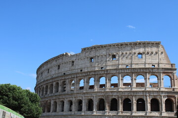 Fototapeta na wymiar colosseum with clear sky background in rome italy Colosseum in rome is among wonders of world and famous tourist destination and ancient amphitheater once used for gladiator fight 