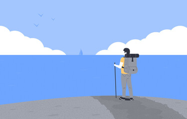 Concept of hiking, adventure tourism and travel. Man with backpack standing on road. Traveler or explorer on the background of ocean. 