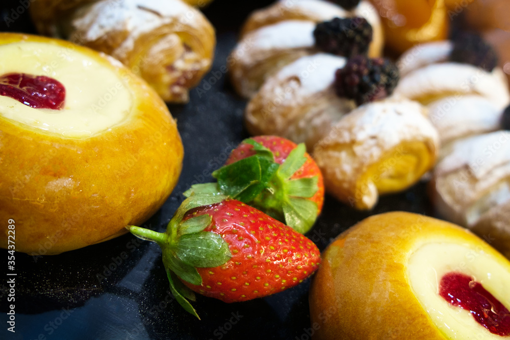 Poster сomposition of cheesecakes and cakes with berries and icing sugar