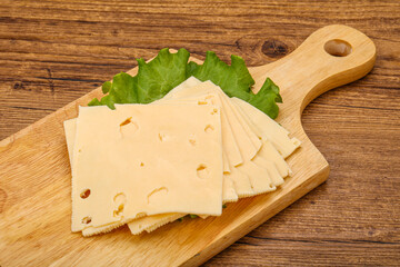 Sliced yellow cheese over board