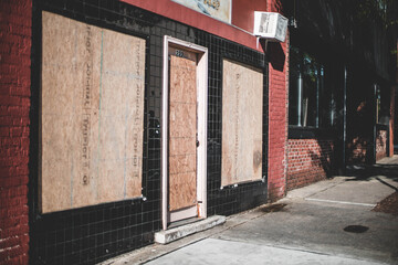 boarded up building in  a city before a riot