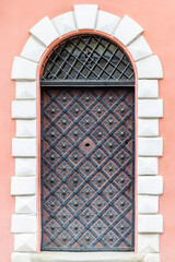 Vintage elegant black metal door of ancient house in an old city.