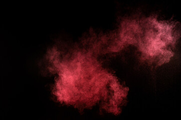 Red and pink powder explosion.Red and pink powder explosion on black background. Colored powder cloud. Colorful dust explode. Paint Holi.