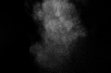 White powder explosion on black background. Abstract white dust texture.