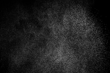 Obraz premium Abstract splashes of water on black background. Freeze motion of white particles. Rain, snow overlay texture.