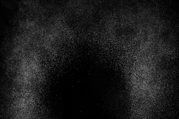 Abstract splashes of water on black background. Freeze motion of white particles. Rain, snow overlay texture.