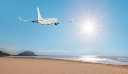 Fototapeta na wymiar A passenger airplane is seen flying with sand dunes on the background sun rays