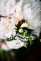 Fototapeta na wymiar Summer wedding decoration. Elegant bridal bouquet with white tender peony flowers macro, closeup, top view.