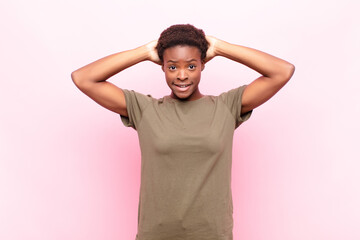 young pretty black womanfeeling stressed, worried, anxious or scared, with hands on head, panicking...