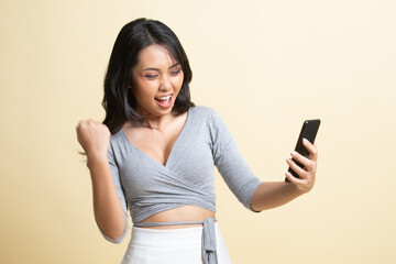 Successful young Asian woman with mobile phone.