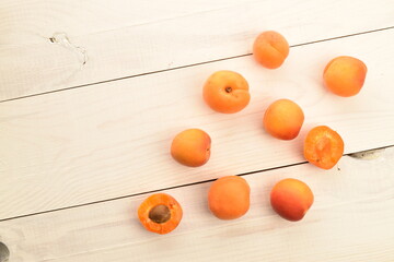 Bright yellow fresh, organic, ripe apricots, close-up, on a painted wooden table.