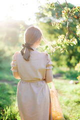 
young girl in a long linen dress, summer photo shoot, girl in the forest, hairstyle with bow