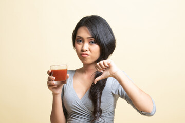 Asian woman thumbs down  hate tomato juice.