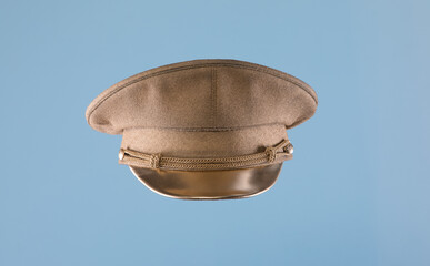 golden military cap isolated on blue background