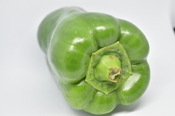 Green bell pepper on white background.