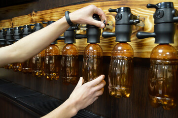 Seller pours beer through defoamer in draft beer store