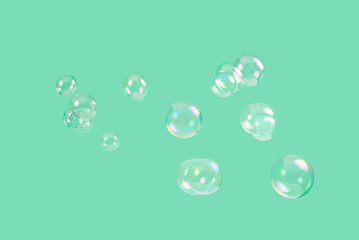 Soap bubbles isolated on a green background.