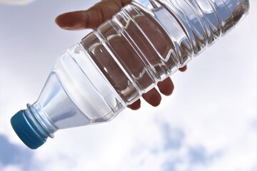 Blur hand picking fresh plastic water bottle.photo 