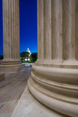 U.S. Capital Building dome as seen through the Supreme Court columns.
