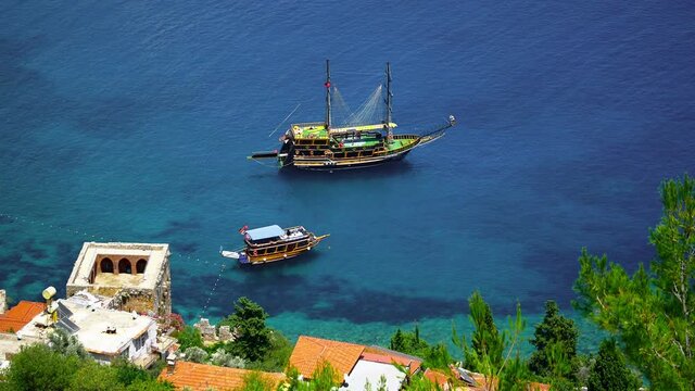 Tourist tour boat anchored on the calm waters of Alanya Harbor. Gulet is a traditional design of a two-masted wooden sailing vessel from southwestern coast of Turkey, built in the coastal towns of Bod