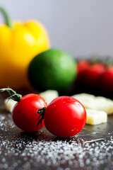 Tomatoes and cheese. Red cherry tomato and Parmesan. Cooking in the kitchen at home.