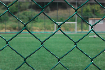 metal wire fence with soccer field