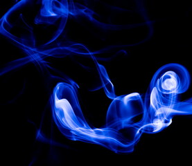 Blue smoke on black background