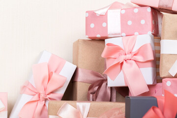 Group of gifts on a wooden table. Gift boxes with bows. beige background