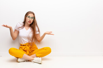 yound blonde woman feeling puzzled and confused, unsure about the correct answer or decision,...