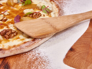 Pizza on wood decorated with spreaded wheat