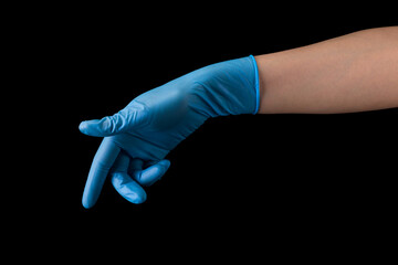 Doctor's hand in medical gloves touching screen by finger isolated on black