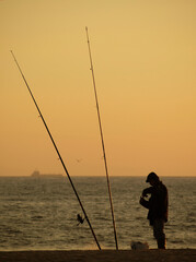 A fisherman fishing at sunset, Povoa de Varzim, Braga, Portugal.