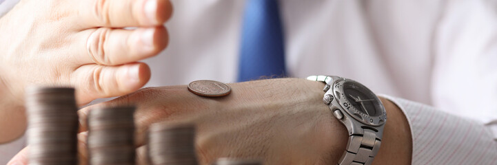 Man put coin on back his hand, counting money