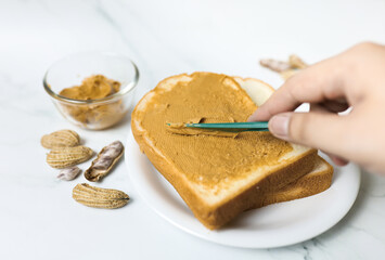 peanut butter on bread with knife