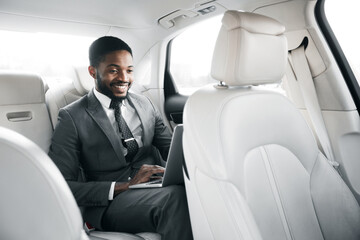 Entrepreneur Using Laptop Making Video Call Sitting In Car