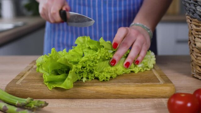 cooking green salad on a wooden board