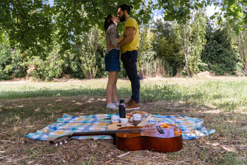 A couple having a picnic in the middle of nature. Having breakfast and enjoying the day.
