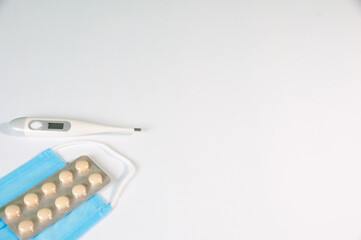 Tablets And A Protective Blue Mask Lie On A White Background