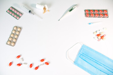 Tablets And A Protective Blue Mask Lie On A White Background