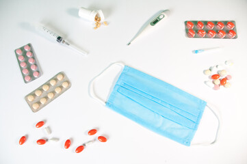 Tablets And A Protective Blue Mask Lie On A White Background