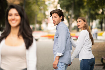 Jealous Girlfriend Calling Boyfriend Distracted By Other Attractive Woman - obrazy, fototapety, plakaty