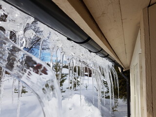 clear icicles hanging from a roof