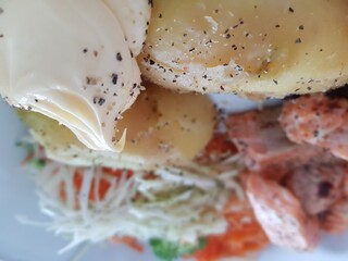 fresh norwegian salmon dinner on plate with potatoes, salad and quark