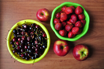 Cherries, strawberries, apples on the table