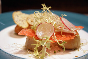 salmons and scallops on a plate with salad