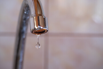 Close-up drop of water from a faucet
