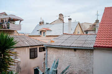 Tiled roof of old europian town with a cat on it.. Split, Croatia.