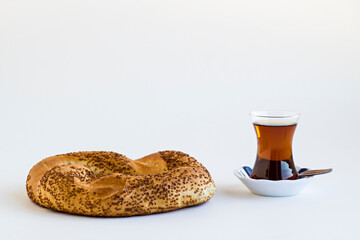 Traditional,Crunchy Turkish Bagel,Simit with Turkish Tea on the white surface with copy space